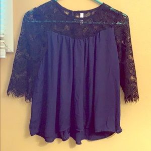 Dressy blouse with black lace sleeves.